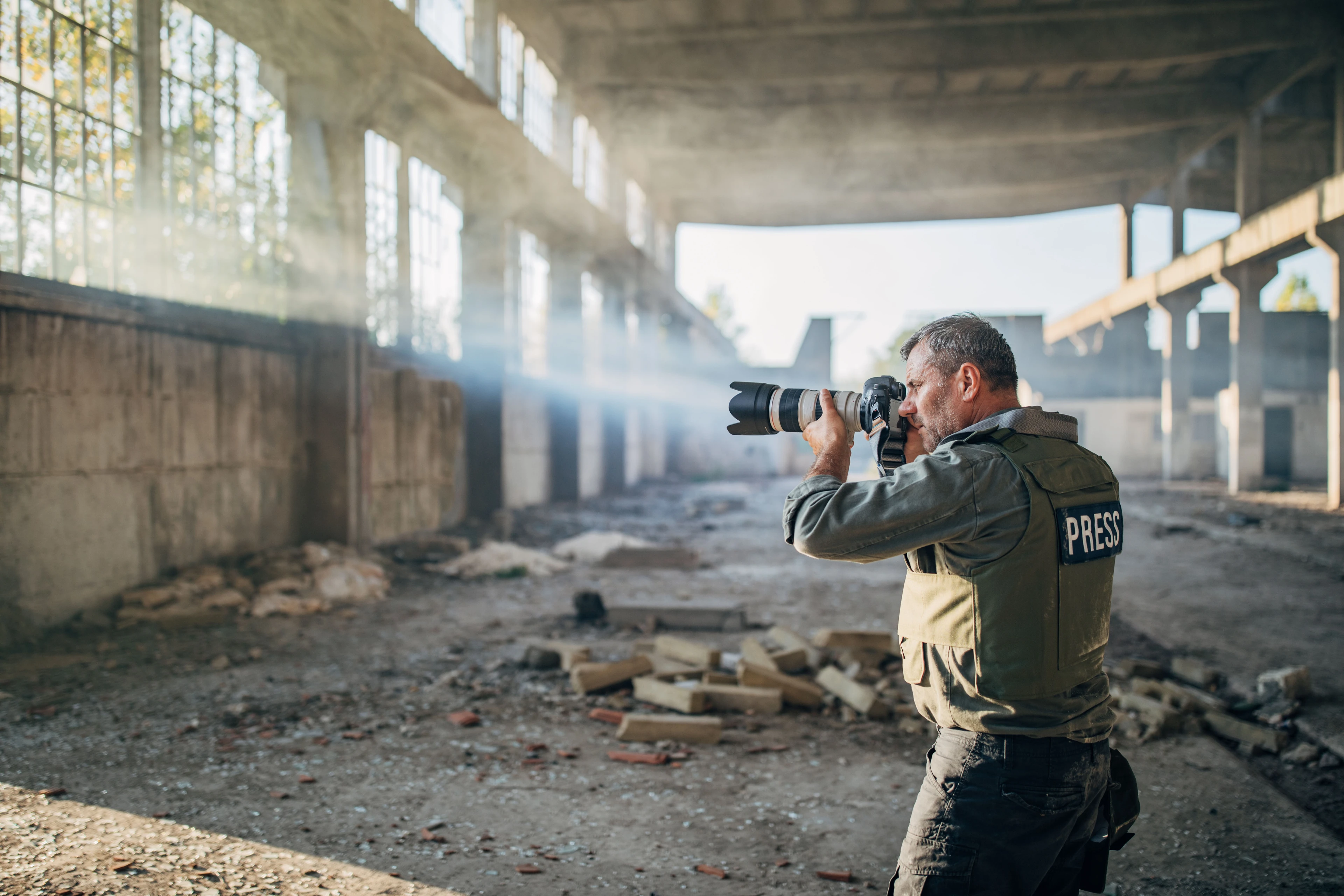 A photojournalist capturing a photo in an abandoned building