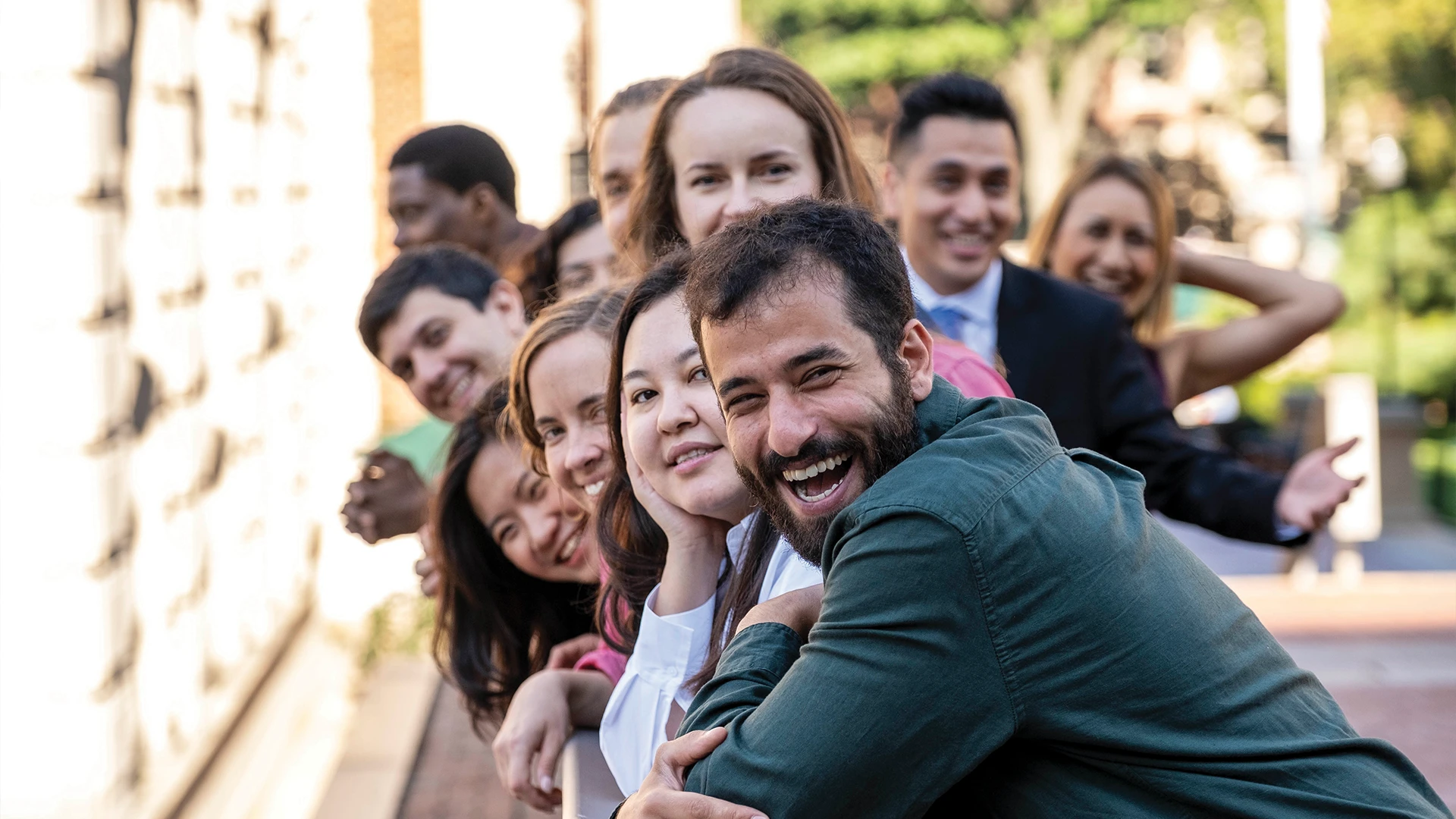 A diverse group of individuals sitting on the steps of a Columbia University building.